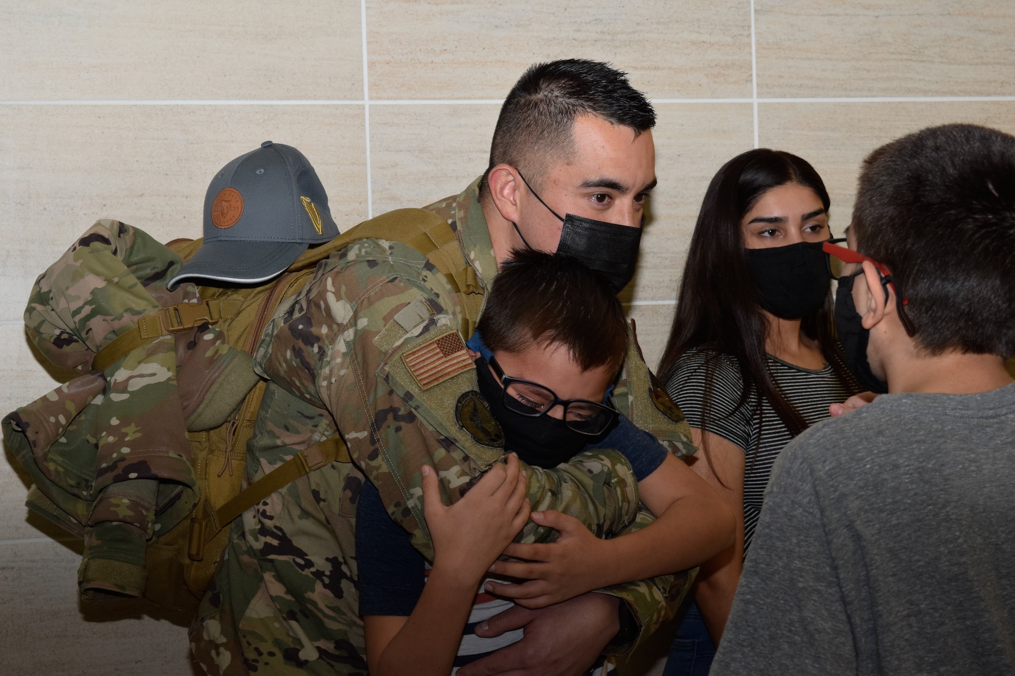 Tech. Sgt. Steven Redgate, 433rd Security Forces Squadron, reunites with his sons, Michael and Atom, and daughter, Desire Casillas, at the airport in San Antonio Jan. 31, 2021. Redgate has been with the 433rd SFS for 10 years and just completed his first deployment. (U.S. Air Force photo by Airman 1st Class Brittany Wich)