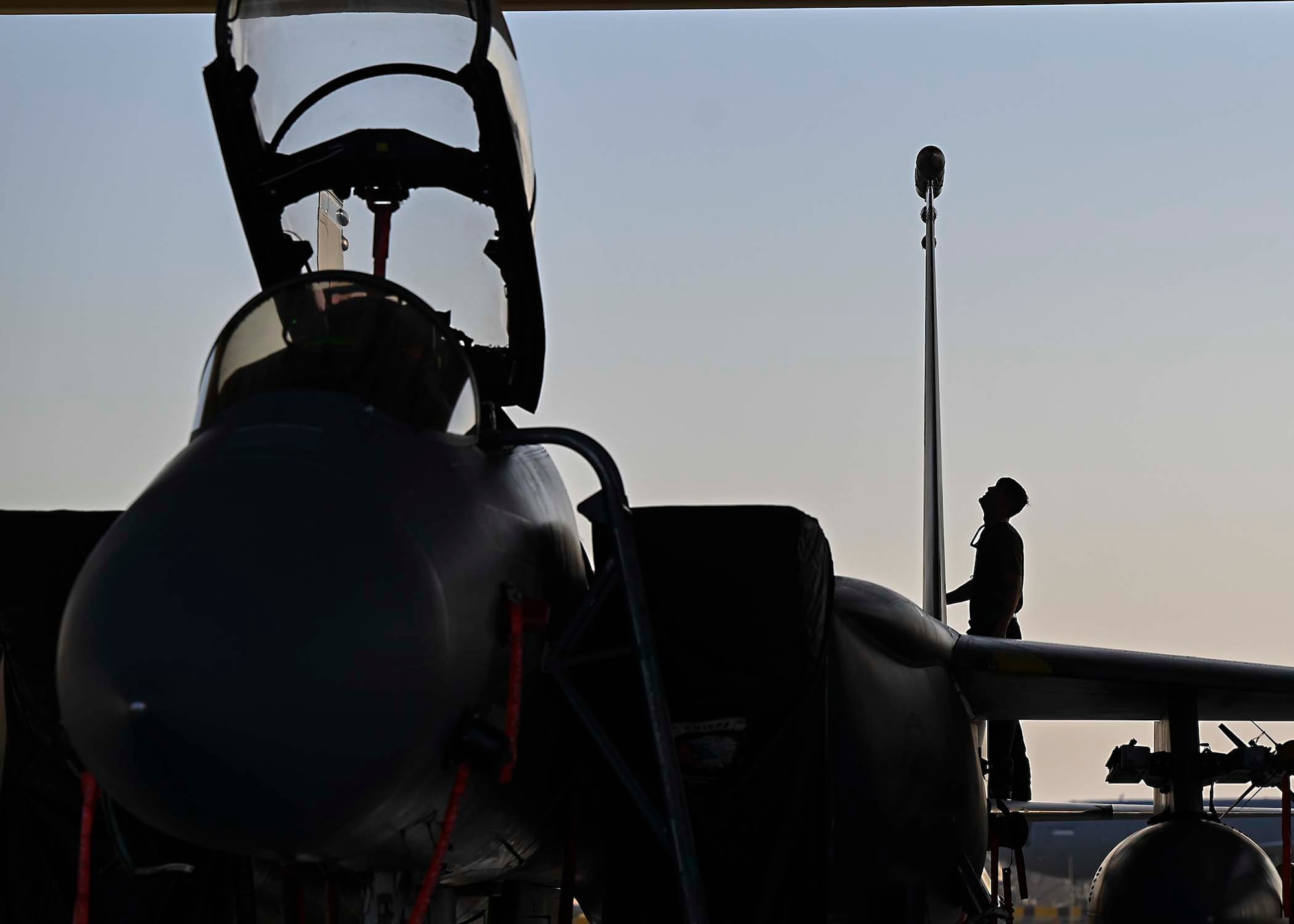 U.S. Air Force Senior Airman Austin Chamberlin, 380th Expeditionary Aircraft Maintenance Squadron F-15E Strike Eagle dedicated crew chief, performs inspections on an F-15E deployed to Al Dhafra Air Base, United Arab Emirates, Jan. 19, 2021.