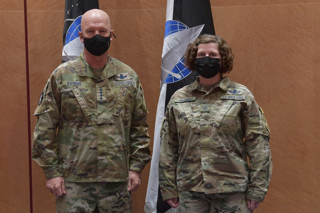 Guardians standing in front of U.S. Space Force flags.