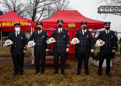 From left to right Captains Joshua Tomson, Rodger Hill, Jonathan Harvey, Troy Ellis and Jeremy Brown stand for a photograph with their new captain’s fire helmets. These five firefighters were promoted to captain during a promotion ceremony held at Norfolk Naval Shipyard’s (NNSY’s) Trophy Park on Monday, Feb. 1. These newly promoted captains will be assigned to NNSY and Naval Weapons Station Yorktown, Fire District 2.