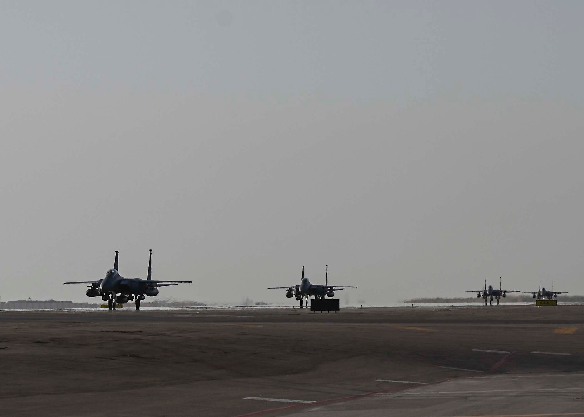 U.S. Air Force F-15E Strike Eagles assigned to the 335th Expeditionary Fighter Squadron (EFS) taxi at Al Dhafra Air Base (ADAB), United Arab Emirates, Jan. 19, 2021.