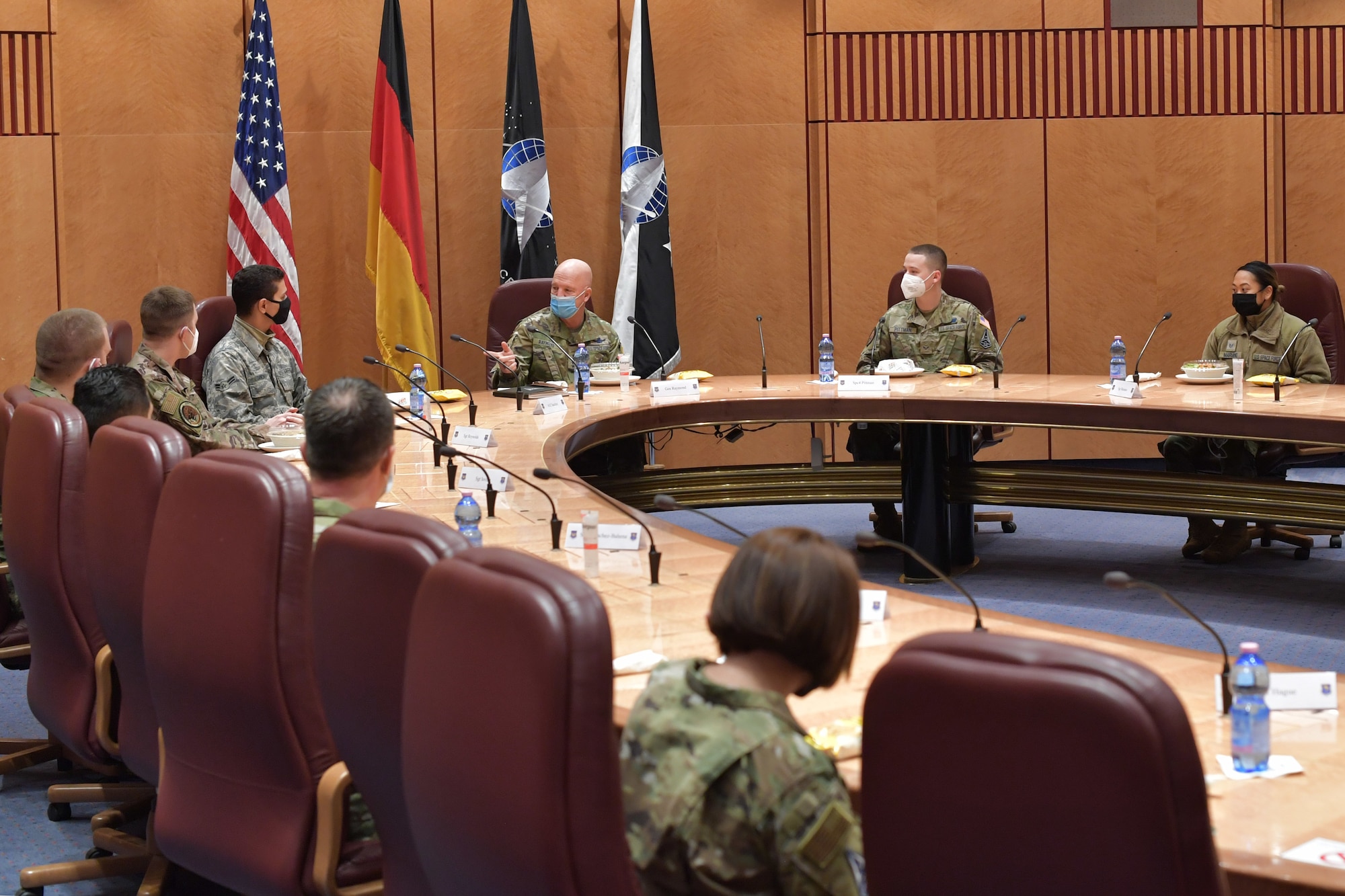 Guardians and Airmen sitting around a conference table.