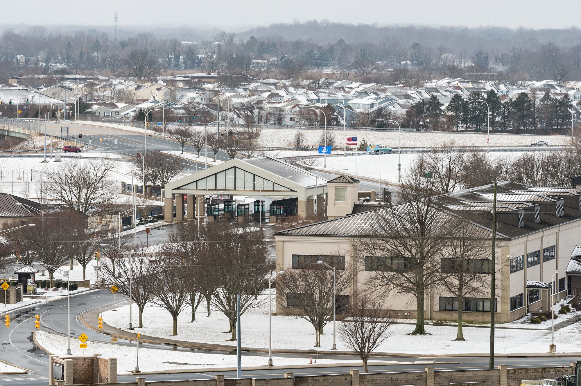 A view from the air traffic control tower of the main-gate area after a nor’easter produced snow showers at Dover Air Force Base, Delaware, Feb. 2, 2021. As snow fell, the base continued normal operations and prepared for additional forecast snowfall during the next day. (U.S. Air Force photo by Roland Balik)