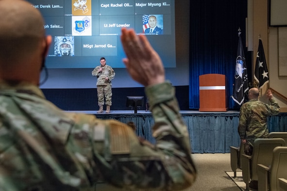 Lt. Gen. B. Chance Saltzman, U.S. Space Force deputy chief of Space Operations for Operations, Cyber and Nuclear, leads Airmen in a ceremonial oath of office and enlistment into the Space Force during a transfer ceremony on Maxwell Air Force Base, Alabama, Feb. 2, 2021. The 110 new Guardians, who attended the ceremony in person and virtually, represented units and mission partners across the Maxwell-Gunter installation, to include Air University and the Air Force Institute of Technology at Wright Patterson Air Force Base, Ohio.