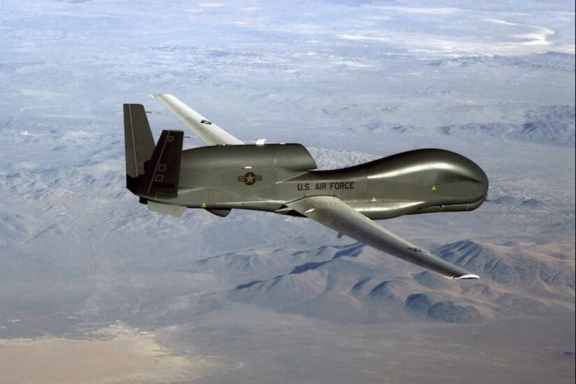 An RQ-4 Global Hawk flies across the sky.