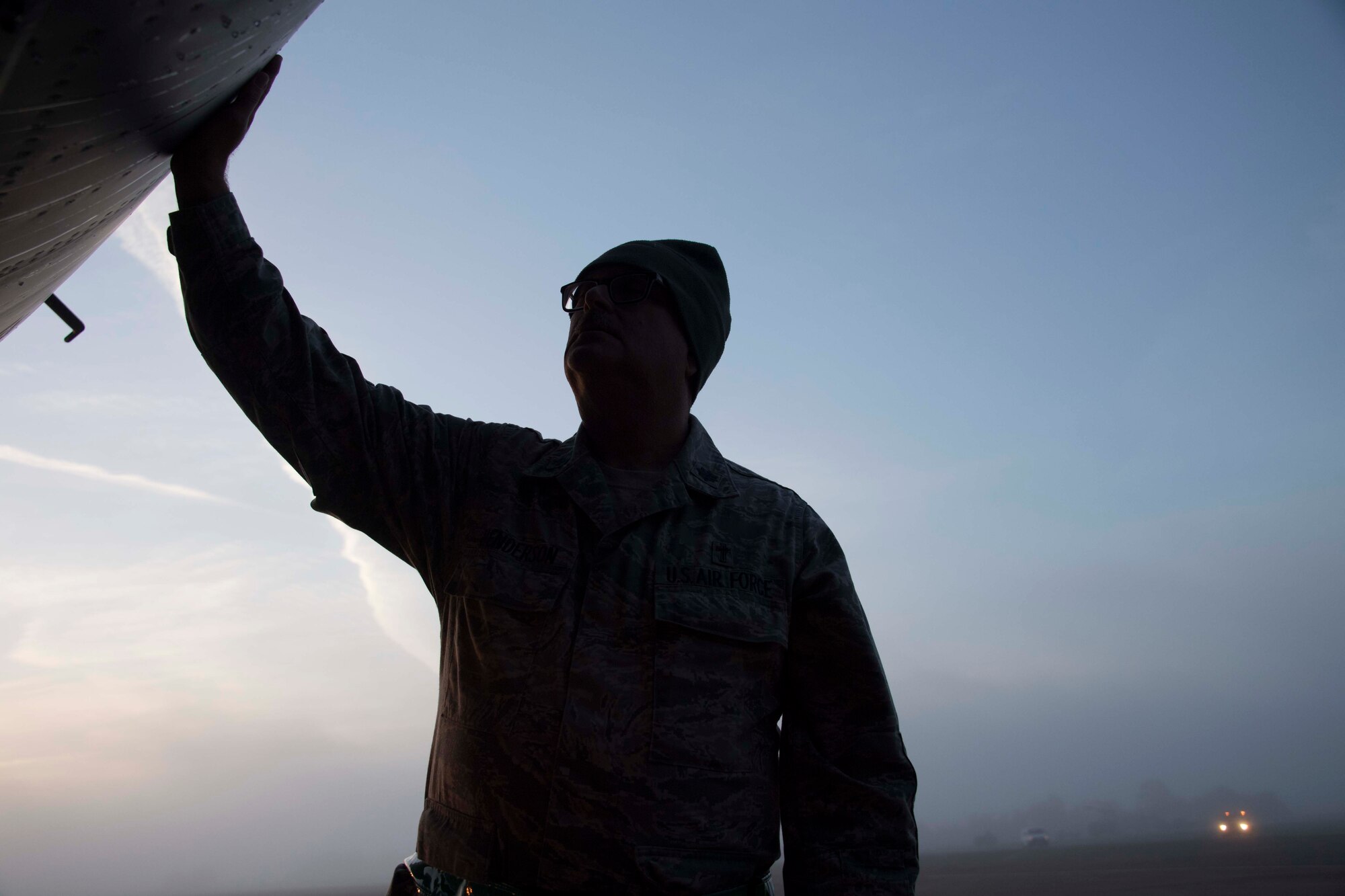 Photo of Airman touching a plane