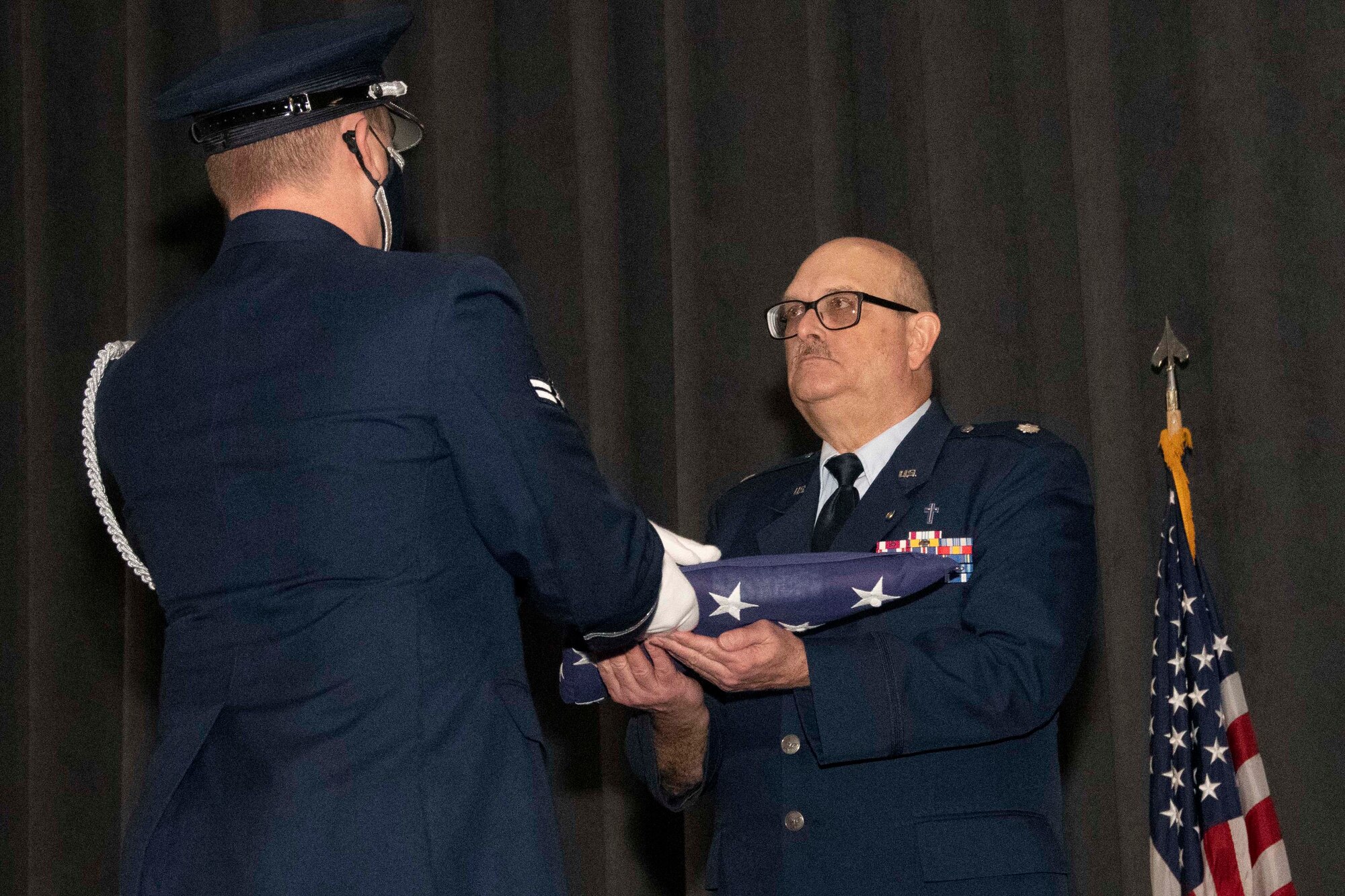 Airman accepts a U.S. Flag