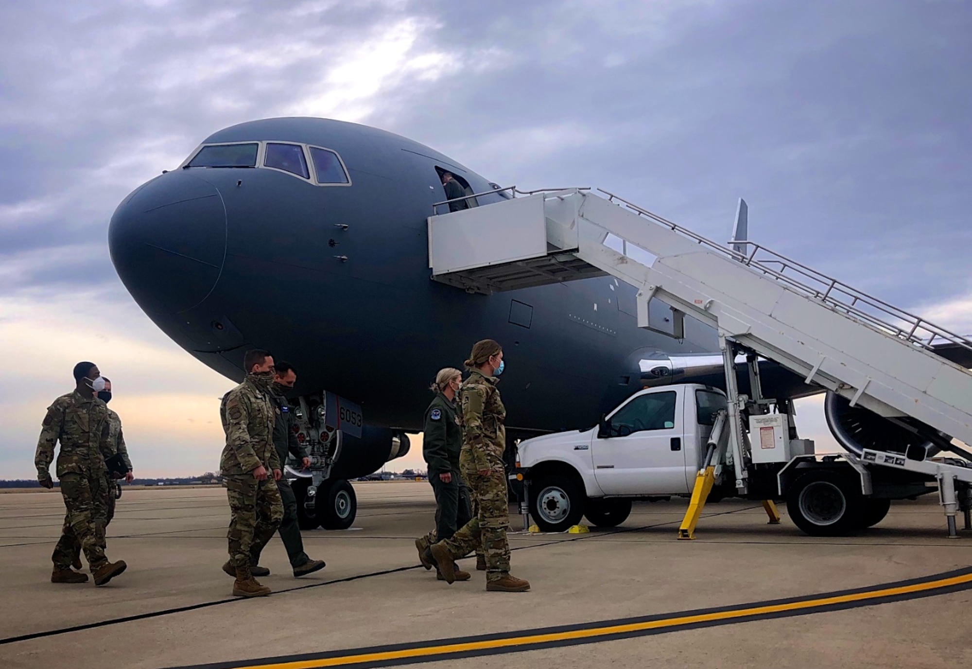 Member of the 932nd Airlift Wing's Aeromedical Evacuation Squadron walk to the stairs of a visiting KC-46 aircraft to get training January 14, 2021, Scott Air Force Base, Ill.  They received crew briefs from aircrew members and had a chance to see how the plane interior and equipment differs from other aircraft they have flown on.  Master Sgt. Anisa Thomas, 932nd Aeromedical Evacuation Squadron said, "as ground personnel we're learning about how we can enter and assist with loading our equipment and work better with crews."  The reserve Citizen Airmen familiarized themselves on the KC-46 Pegasus, as the training helped strengthen and enhance their patient care skills.  During this training they had a chance to ask questions and learn directly from a flight crew with the 157th Air Refueling Wing from Pease Air National ,Guard Base, N.H.  (U.S. Air Force photo by Lt. Col. Stan Paregien)
