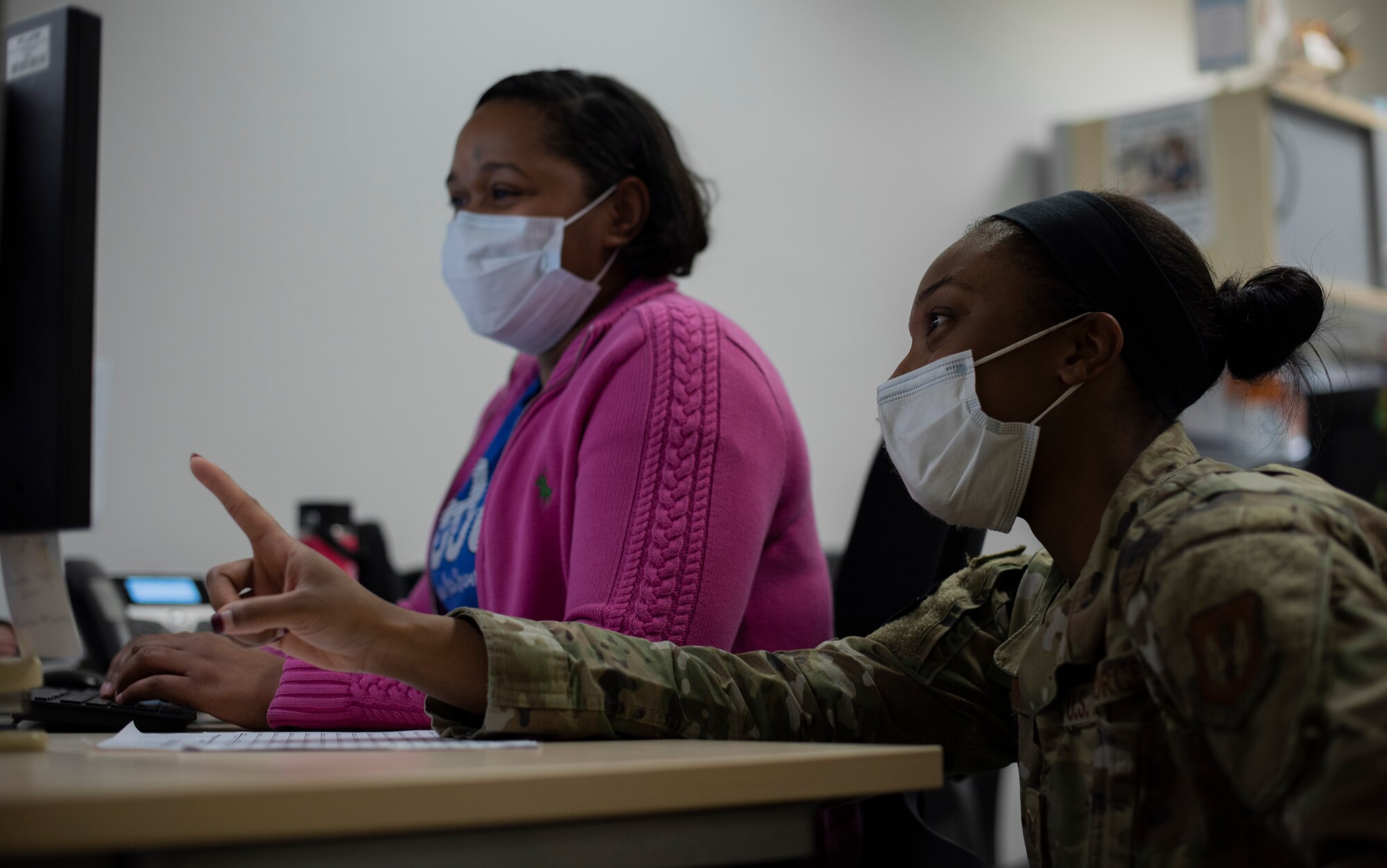 U.S. Air Force Tech. Sgt. Tamara Brown, 86th Medical Support Squadron patient administration section chief, speaks with Robin Robinson, 86th MDSS medical support assistant, at Ramstein Air Base, Germany, Feb. 3, 2021.