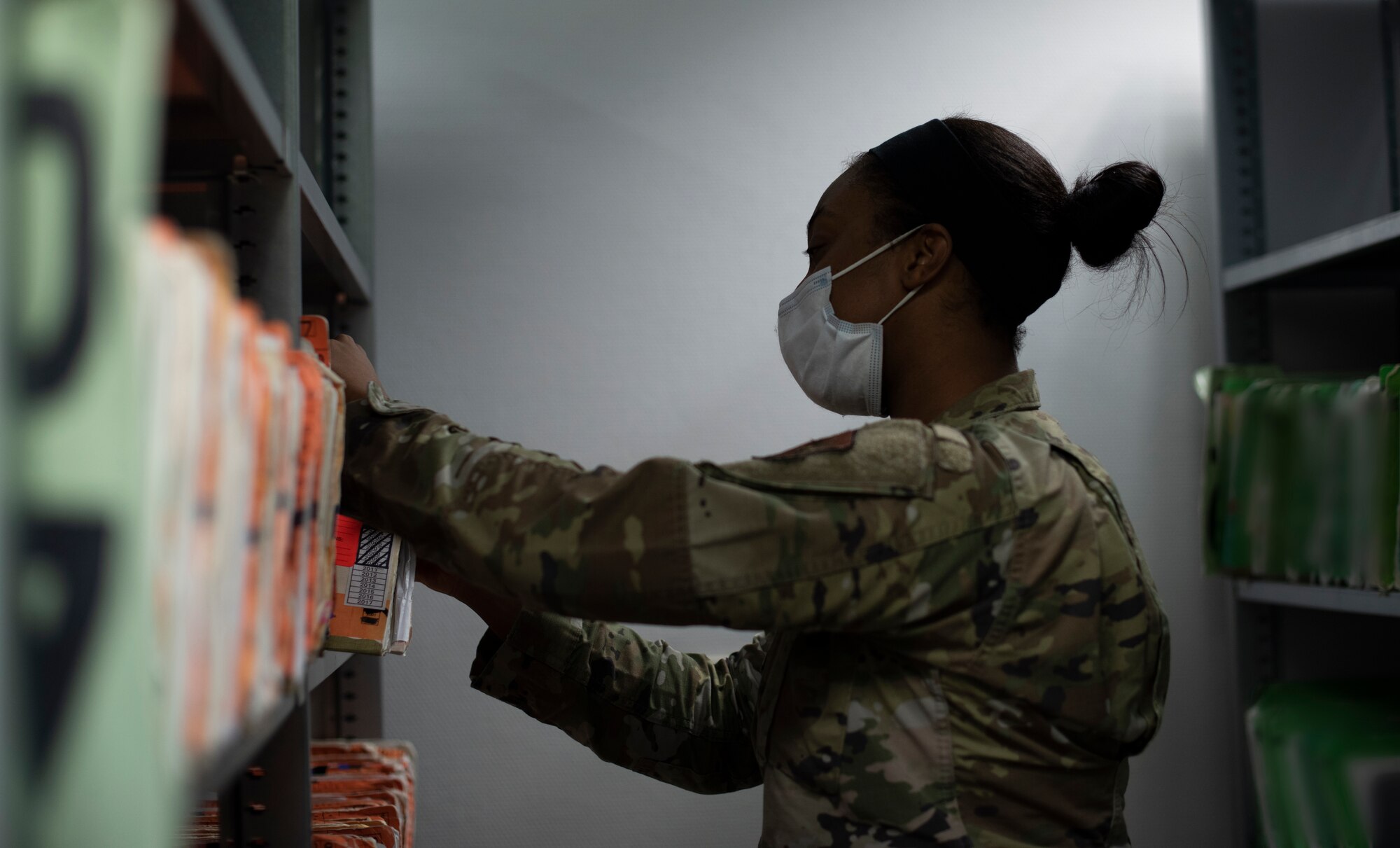 U.S. Air Force Tech. Sgt. Tamara Brown, 86th Medical Support Squadron patient administration section chief, looks through patient medical records at Ramstein Air Base, Germany, Feb. 3, 2021.
