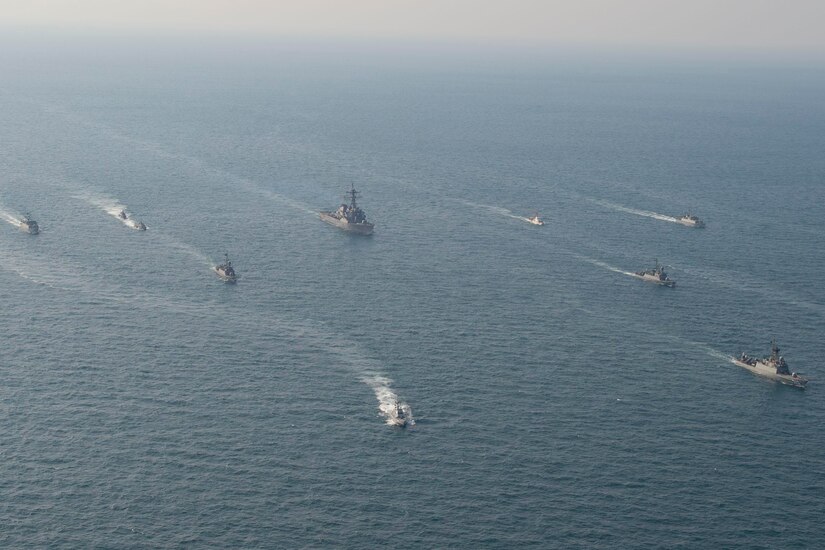 A large group of ships sail across the Persian Gulf.
