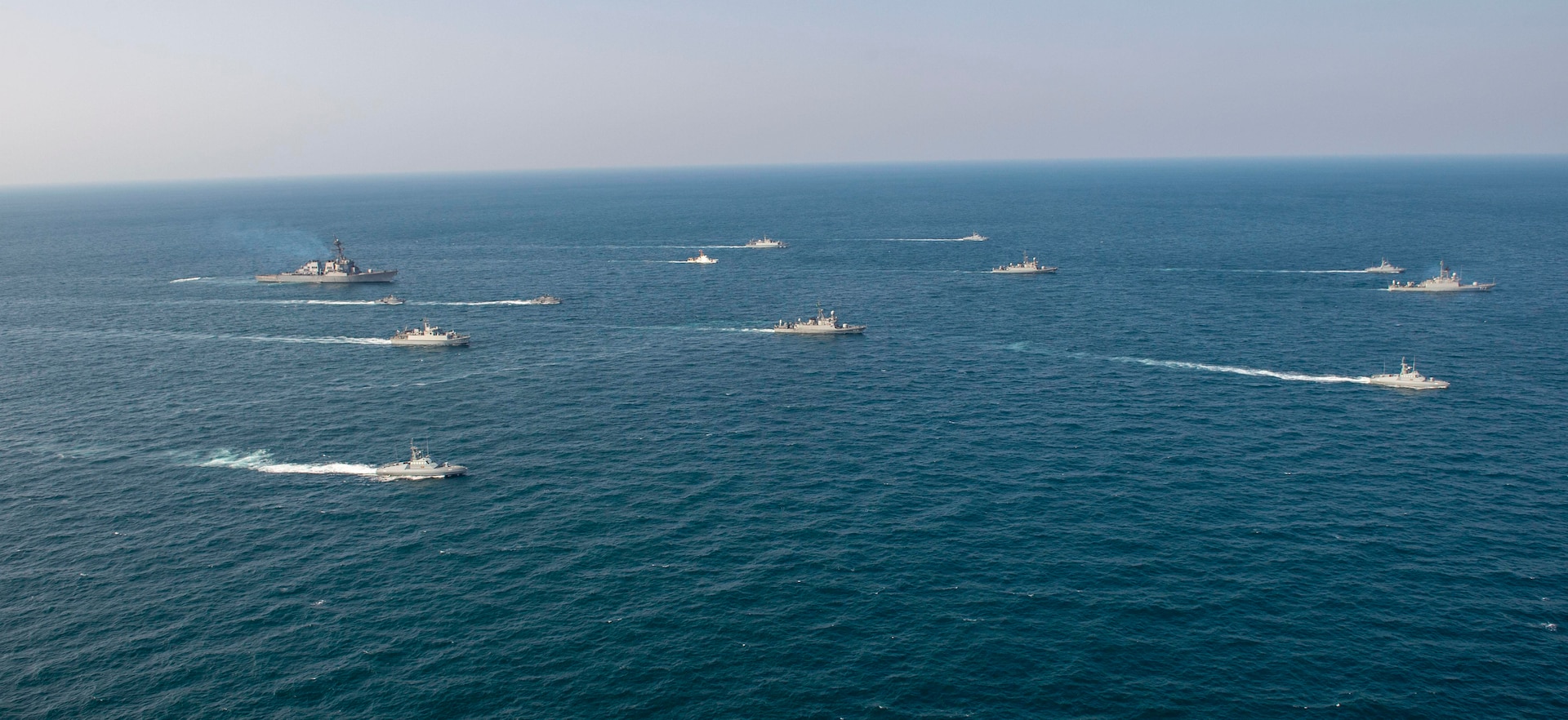 210124-N-XG173-1567 ARABIAN GULF (Jan. 24, 2020) Royal Saudi Naval Force ships and U.S. Navy sail in formation during exercise Nautical Defender (ND) 21 in the Arabian Gulf, Jan. 24. ND 21 is the capstone in a series of multi-national maritime security exercises designed to broaden levels of cooperation, support long-term regional security, and enhance military-to-military interoperability between the Kingdom of Saudi Arabia, UK and the U.S. (U.S. Navy photo by Mass Communication Specialist 2nd Class Aja Bleu Jackson)
