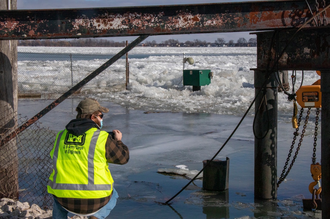 U.S. Army Corps of Engineers Senior Hydraulic Engineer Matt McClerren checks on Corps of Engineers gages on St. Clair River with ice around equipment.
