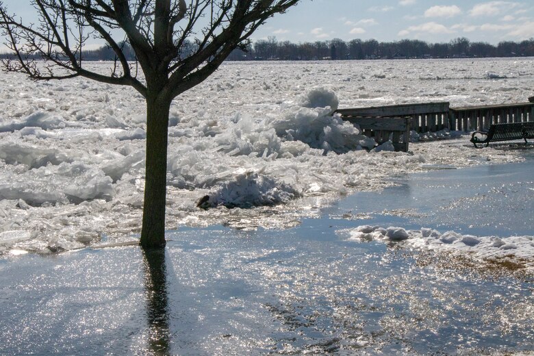 Ice jam on St. Clair river, with banks overflowing and ice buildup around docks and park areas