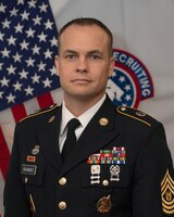 Command photo of CSM Dojaquez in his Army Service Uniform in front of the American Flag and the BN Colors.