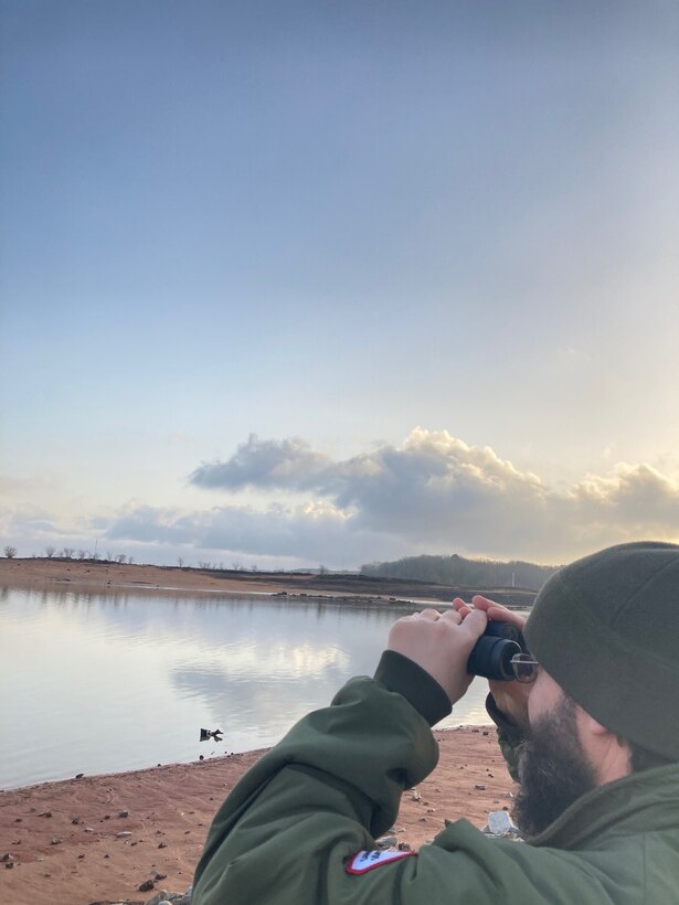 Natural Resources Management Specialist Shea Staten uses binoculars to search for eagles at Sardis Lake during the U.S. Army Corps of Engineers (USACE) Vicksburg District’s mid-winter bald eagle survey in January. A total of 50 eagles, along with other species, were counted across Arkabutla, Sardis, Enid and Grenada lakes during the 2021 survey.