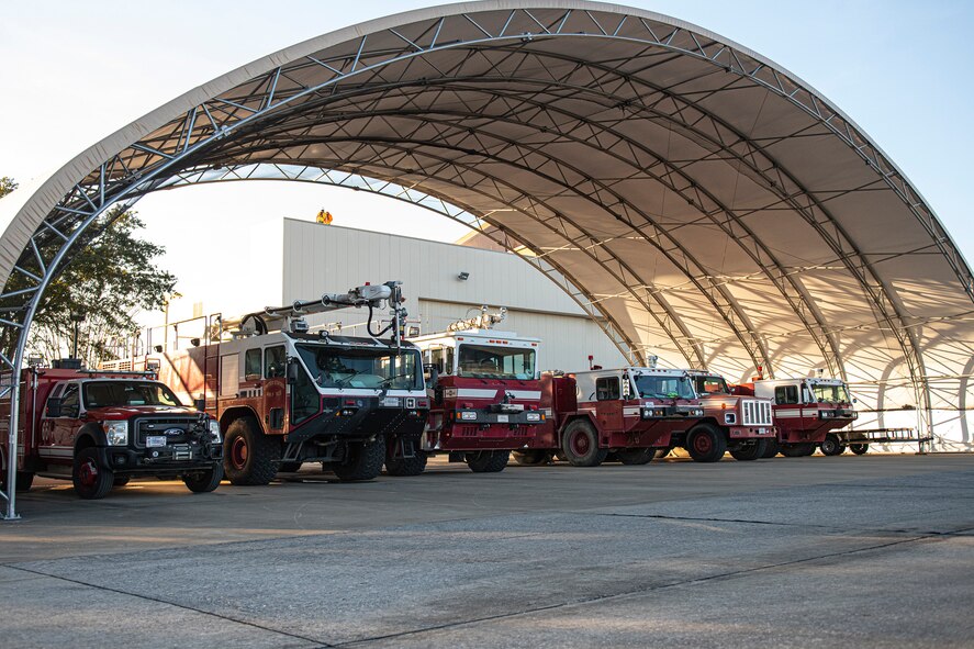 A line of fire-trucks sit parked adjacent to the flightline at Duke Field, Florida, Feb. 3, 2021.