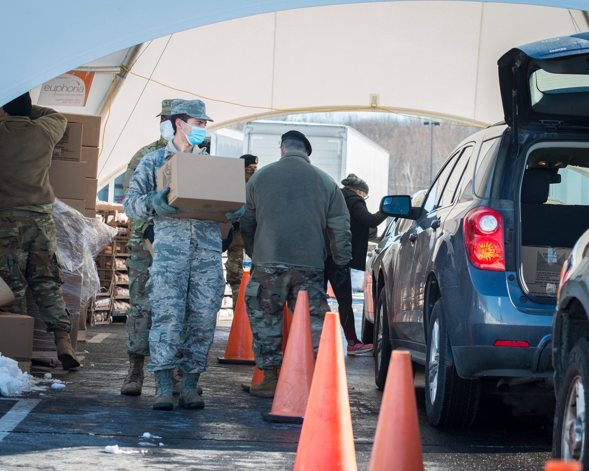 Airmen from the Connecticut National Guard’s 103rd Airlift Wing load U.S. Department of Agriculture Farmers to Families food boxes into vehicles at Rentschler Field in East Hartford, Connecticut, Feb. 4, 2021. Airmen are supporting logistics operations at Foodshare’s drive-thru emergency distribution site here, which has distributed over 8,000,000 pounds of food to 233,000 cars since April 20, 2020. (U.S. Air National Guard photo by Staff Sgt. Steven Tucker)