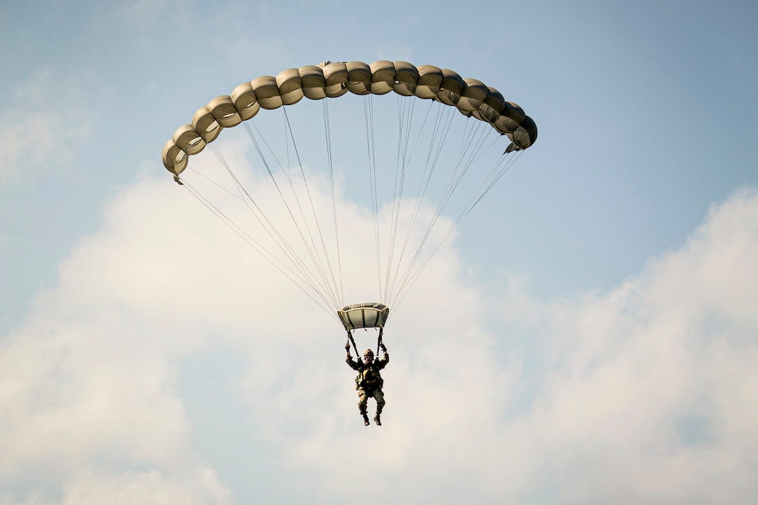 A Marine freefalls with a parachute.