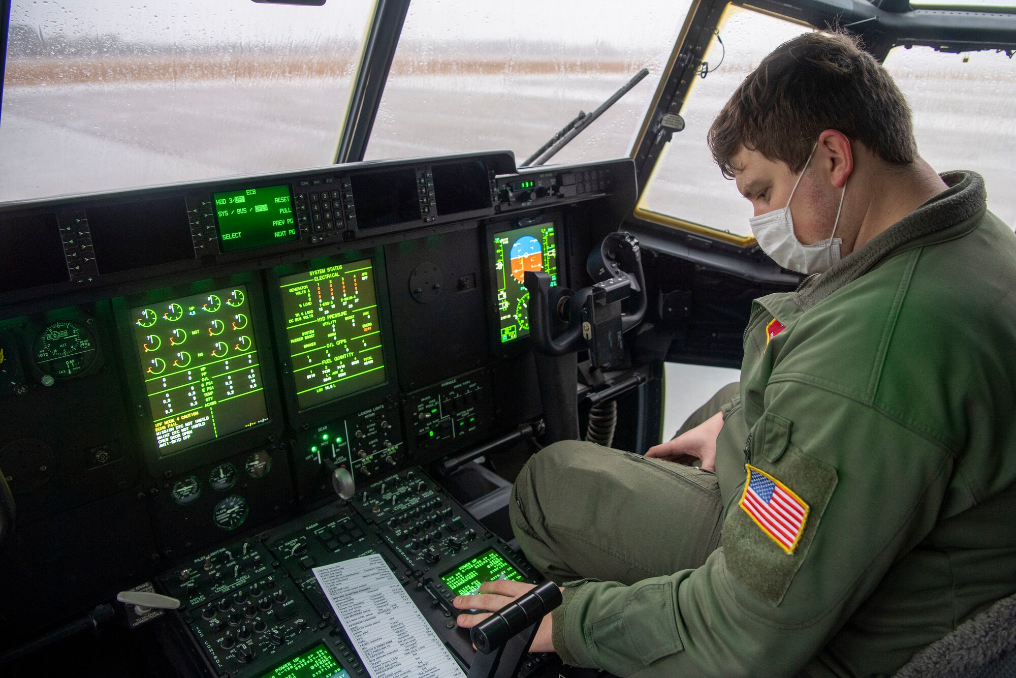 A loadmaster performs a pre-flight check.