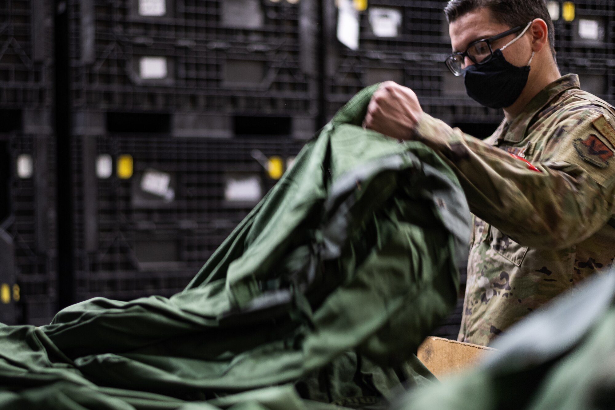 Photo of an Airman grabbing a deployment bag