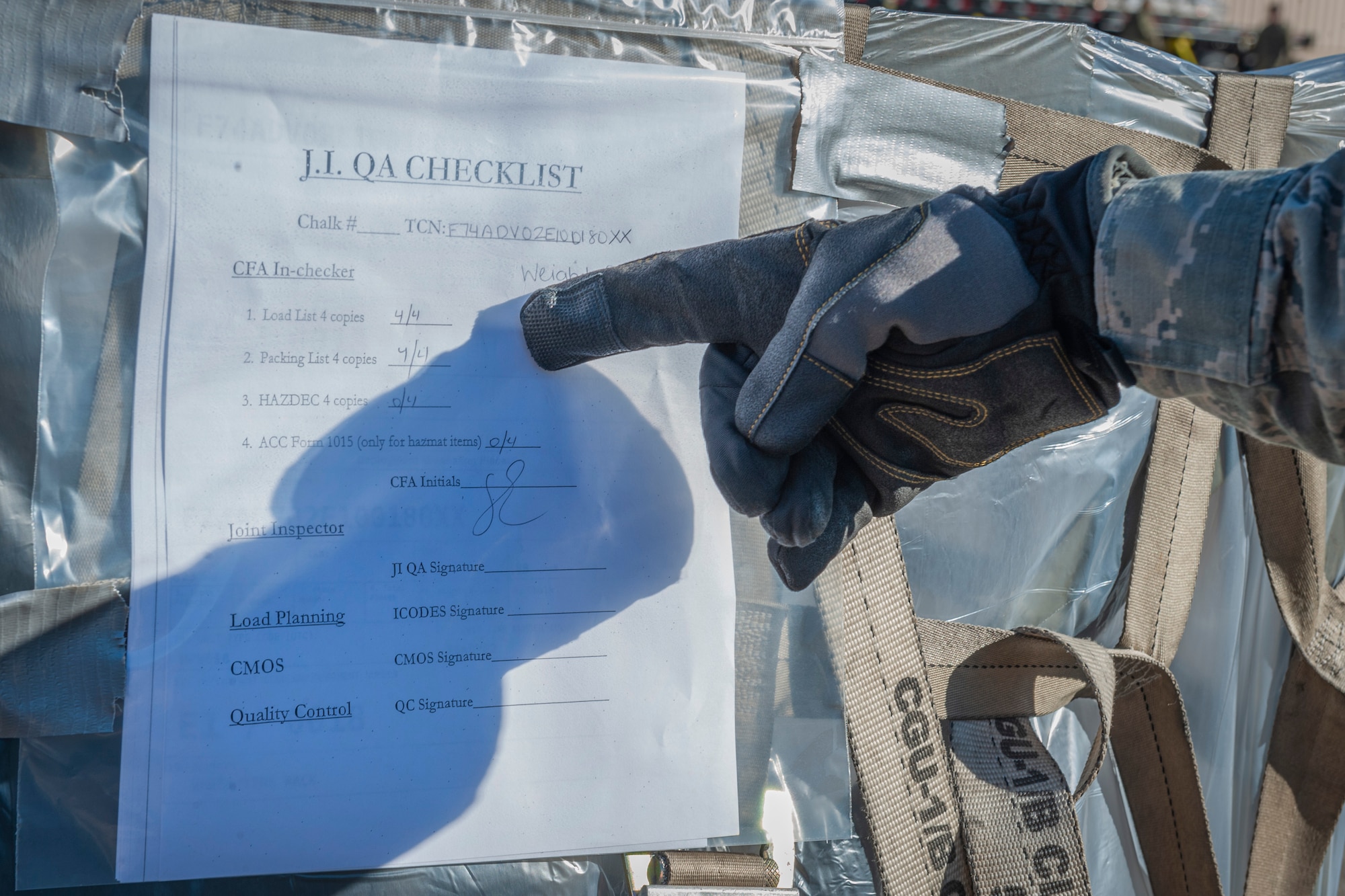Photo of an Airman verifying a checklist