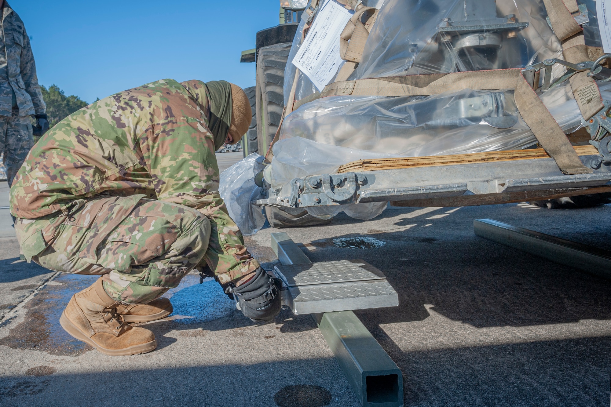 Photo of an Airman weighing cargo