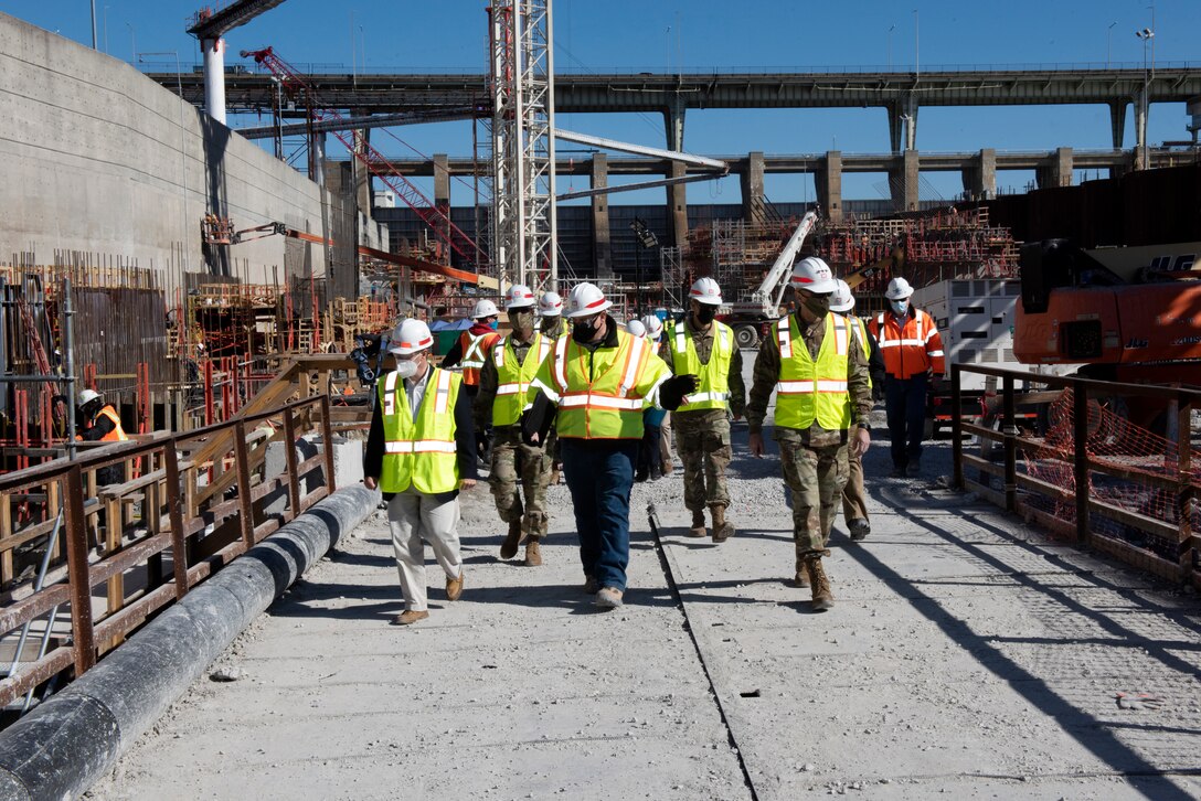 Tommy Long (Center), U.S. Army Corps of Engineers Nashville District’s resident engineer for the Chickamauga Lock Replacement Project, leads Lt. Gen. Scott Spellmon (Right), 55th chief of Engineers, and Congressman Chuck Fleischmann, Tennessee District 3, through the construction site where crews are constructing the lock chamber Feb. 3, 2021. (USACE photo by Lee Roberts)