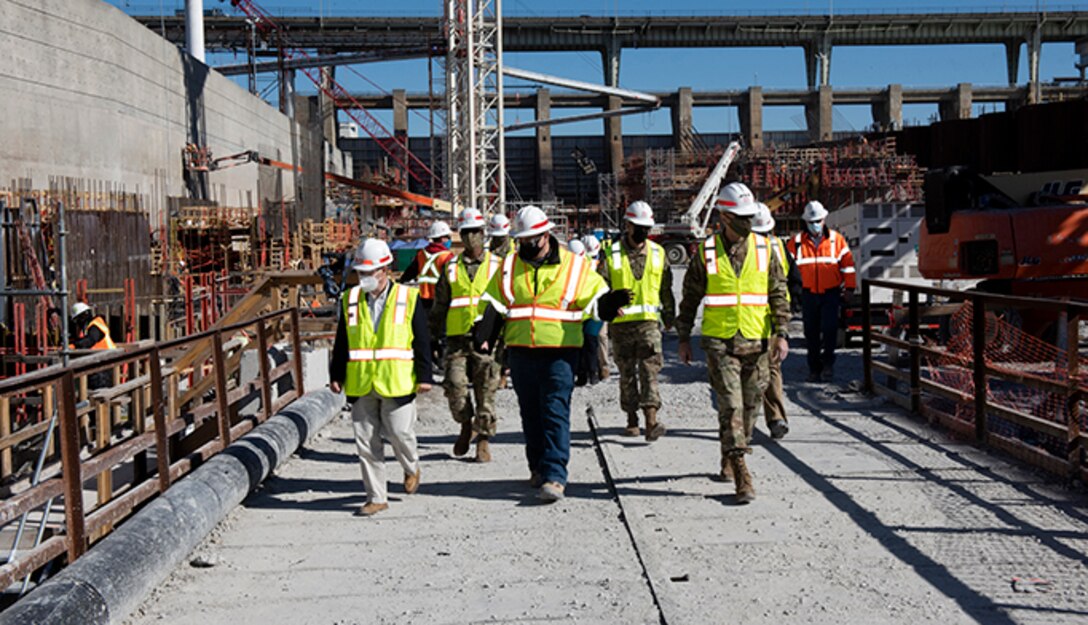 Tommy Long (Center), U.S. Army Corps of Engineers Nashville District’s resident engineer for the Chickamauga Lock Replacement Project, leads Lt. Gen. Scott Spellmon (Right), 55th chief of Engineers, and Congressman Chuck Fleischmann, Tennessee District 3, through the construction site where crews are constructing the lock chamber Feb. 3, 2021. (USACE photo by Lee Roberts)