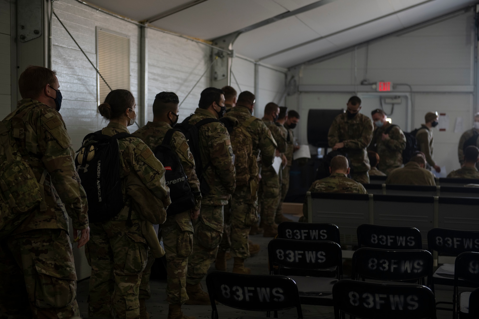 U.S. Air National Guardsmen with the 158th Fighter Wing, Vermont National Guard wait in line to be weighed on Tyndall Air Force Base, Florida, Jan. 30, 2021. In preparation to onboard a C-130 Hercules, passengers are weighed in full uniform with their bags to calculate an accurate weight for the flight. (U.S. Air Force photo by Airman 1st Class Tiffany Price)