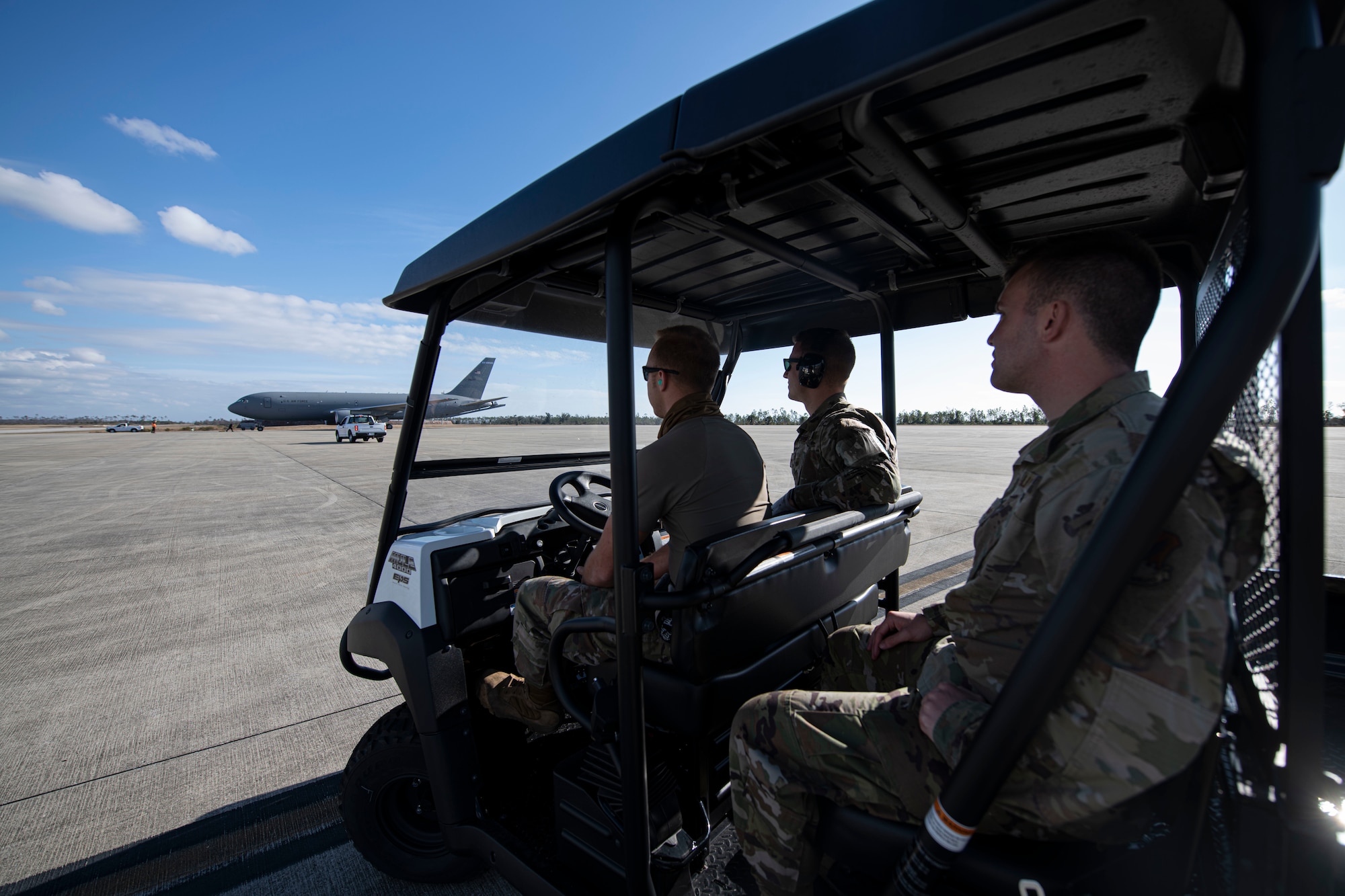 From left, U.S. Air Force Staff Sgt. Brady Runk, 325th Logistics Readiness Squadron air transportation function supervisor, U.S. Senior Airman Evan Keough, 325th LRS air transportation function journeyman and U.S. Air National Guardsman Senior Airman Hunter Smith, 601st Air Operations Center airlift requirements planner watch a KC-46 Pegasus land on Tyndall Air Force Base, Florida, Jan. 30, 2021. The air transportation flight ensures all cargo is air worthy and safe for flight operations. (U.S. Air Force photo by Airman 1st Class Tiffany Price)