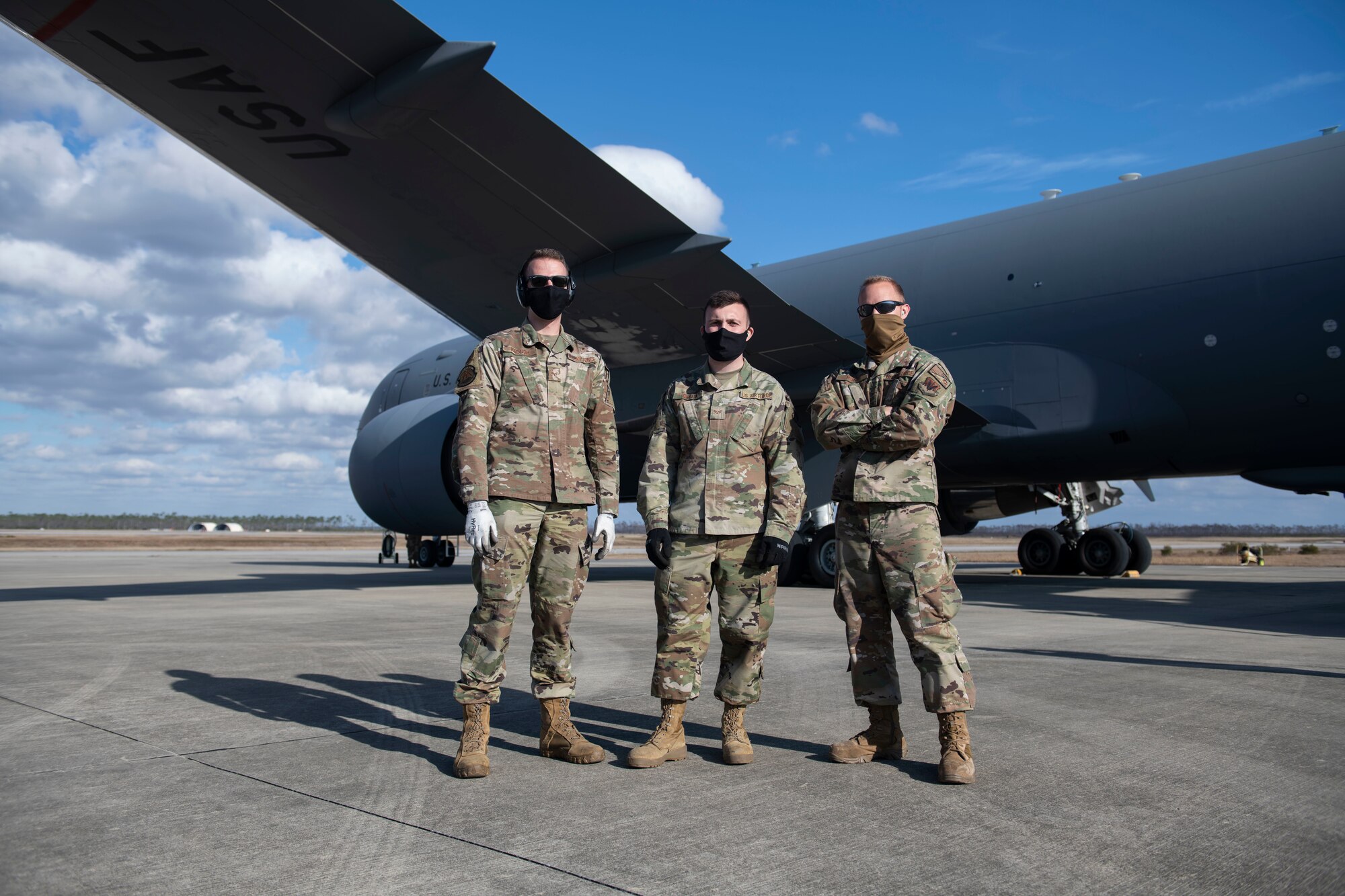 From left, U.S. Air Force Senior Airman Evan Keough, 325th Logistics Readiness Squadron air transportation function journeyman, U.S. Air National Guardsman Senior Airman Hunter Smith, 601st Air Operations Center airlift requirement planner, and U.S. Air Force Staff Sgt. Brady Runk, 325th LRS air operations function supervisor pose for a photo in front of a KC-46 Pegasus on Tyndall Air Force Base, Florida, Jan. 30, 2021. The air transportation flight ensures all cargo is air worthy and safe for flight operations. (U.S. Air Force photo by Airman 1st Class Tiffany Price)