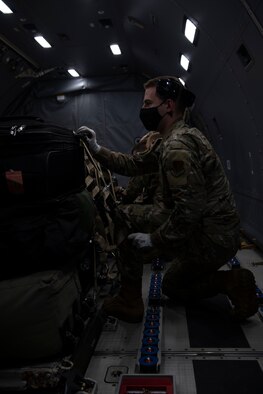 U.S. Air Force Airmen with the 325th Logistics Readiness Squadron air transportation operations flight secure a pallet of cargo inside a KC-46 Pegasus on Tyndall Air Force Base, Florida, Jan. 30, 2021. Before take-off all cargo must be thoroughly inspected to a oid damage to passengers or the aircraft during flight. (U.S. Air Force photo by Airman 1st Class Tiffany Price)