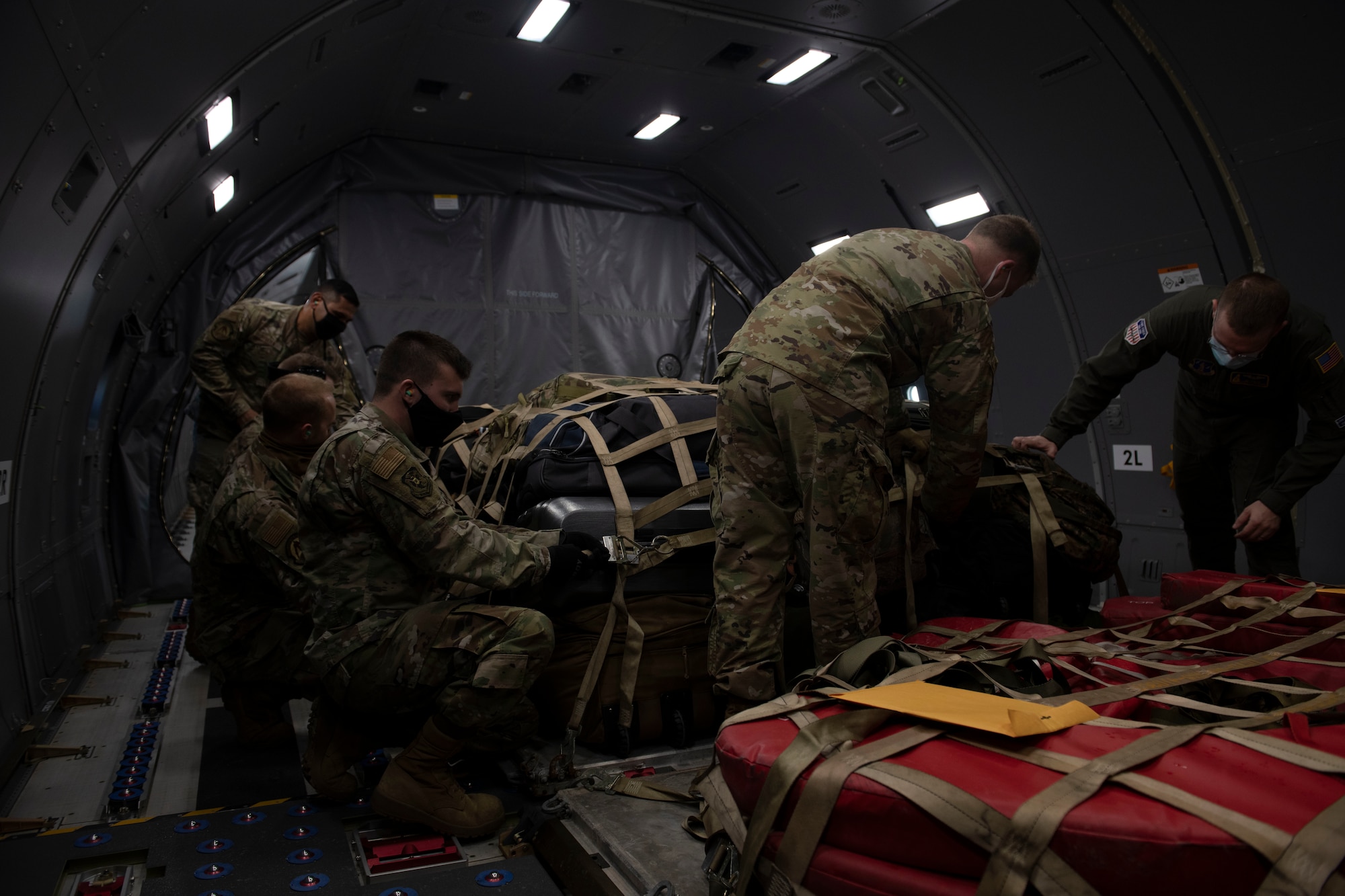 U.S. Air Force Airmen with the 325th Logistics Readiness Squadron air transportation operations flight secure a pallet of cargo inside a KC-46 Pegasus on Tyndall Air Force Base, Florida, Jan. 30, 2021. Before take-off all cargo must be thoroughly inspected to a oid damage to passengers or the aircraft during flight. (U.S. Air Force photo by Airman 1st Class Tiffany Price)