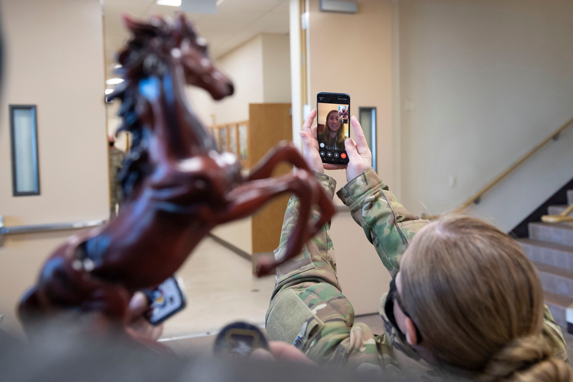 Staff Sgt. Meagan Mackie, 51st Mission Support Group, celebrates via FaceTime on receiving NCO of the Year honors from 51st Fighter Wing leadership during the 51st FW annual awards presentation, Feb. 4, 2021, at Osan Air Base, Republic of Korea. Team Osan unconventionally celebrated the ceremony by visiting the winner’s work centers to emphasize teamwork and camaraderie. (U.S. Air Force photo by Senior Airman Greg Nash)