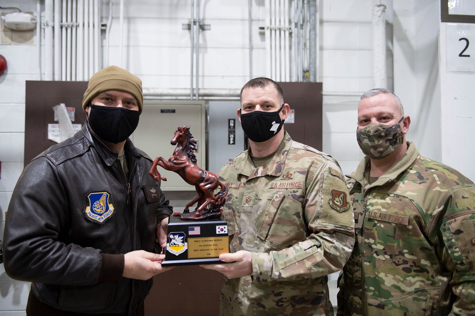 Master Sgt. Clifford Howie, 51st Maintenance Group, middle, receives First Sergeant of the Year honors from 51st Fighter Wing leadership during the 51st FW annual awards presentation, Feb. 4, 2021, at Osan Air Base, Republic of Korea. Team Osan unconventionally celebrated the ceremony by visiting the winner’s work centers to emphasize teamwork and camaraderie. (U.S. Air Force photo by Senior Airman Greg Nash)