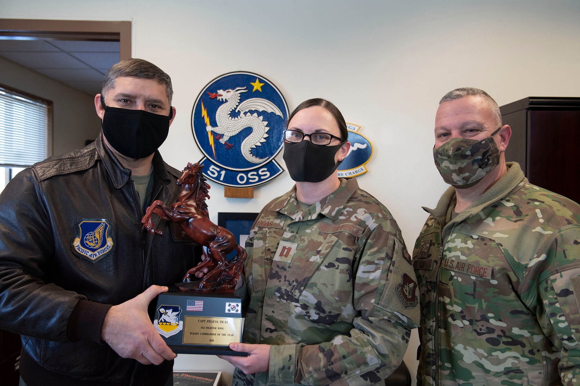 Capt. Felicia Ticas, 51st Operations Support Squadron, middle, receives Flight Commander of the Year honors from 51st Fighter Wing leadership during the 51st FW annual awards presentation, Feb. 4, 2021, at Osan Air Base, Republic of Korea. Team Osan unconventionally celebrated the ceremony by visiting the winner’s work centers to emphasize teamwork and camaraderie. (U.S. Air Force photo by Senior Airman Greg Nash)