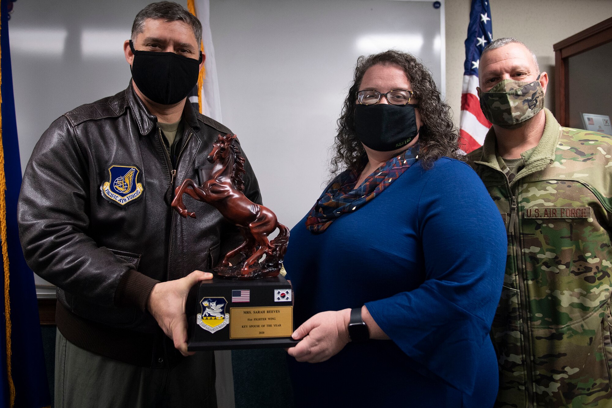 Mrs. Sarah Reeves, middle, receives Key Spouse of the Year honors from 51st Fighter Wing leadership during the 51st FW annual award presentation, Feb. 4, 2021, at Osan Air Base, Republic of Korea. Team Osan unconventionally celebrated the ceremony by visiting the winner’s work centers to emphasize teamwork and camaraderie. (U.S. Air Force photo by Senior Airman Greg Nash)