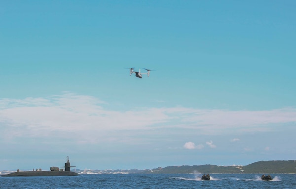 PHILIPPINE SEA (Feb. 2, 2021) An MV-22B Osprey, attached to Marine Medium Tiltrotor Squadron (VMM) 265, and U.S. Marines from Force Reconnaissance Company, III Marine Expeditionary Force (MEF), conduct a movement with the Ohio-class guided-missile submarine USS Ohio (SSGN 726), deployed in U.S. 7th Fleet area of operations, during an integration exercise off the coast of Okinawa, Japan. The exercise was part of ongoing III MEF-U.S. 7th Fleet efforts to provide flexible, forward-postured and quick response options to regional commanders. (U.S Marine Corps photo by Sgt. Destiny Dempsey)
