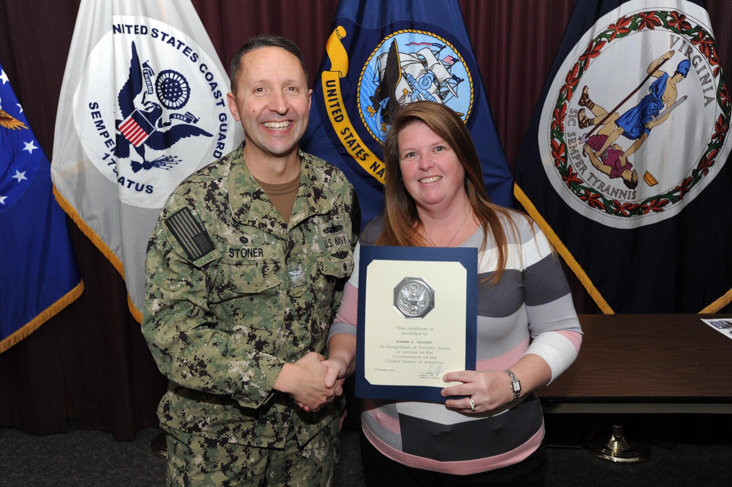 Center for Surface Combat Systems (CSCS) Commanding Officer, Capt. Dave Stoner, recognizes CSCS Financial Management Analyst Mrs. Suzie Kilinski for her 20 years of civilian service at an awards ceremony January 9, 2020.