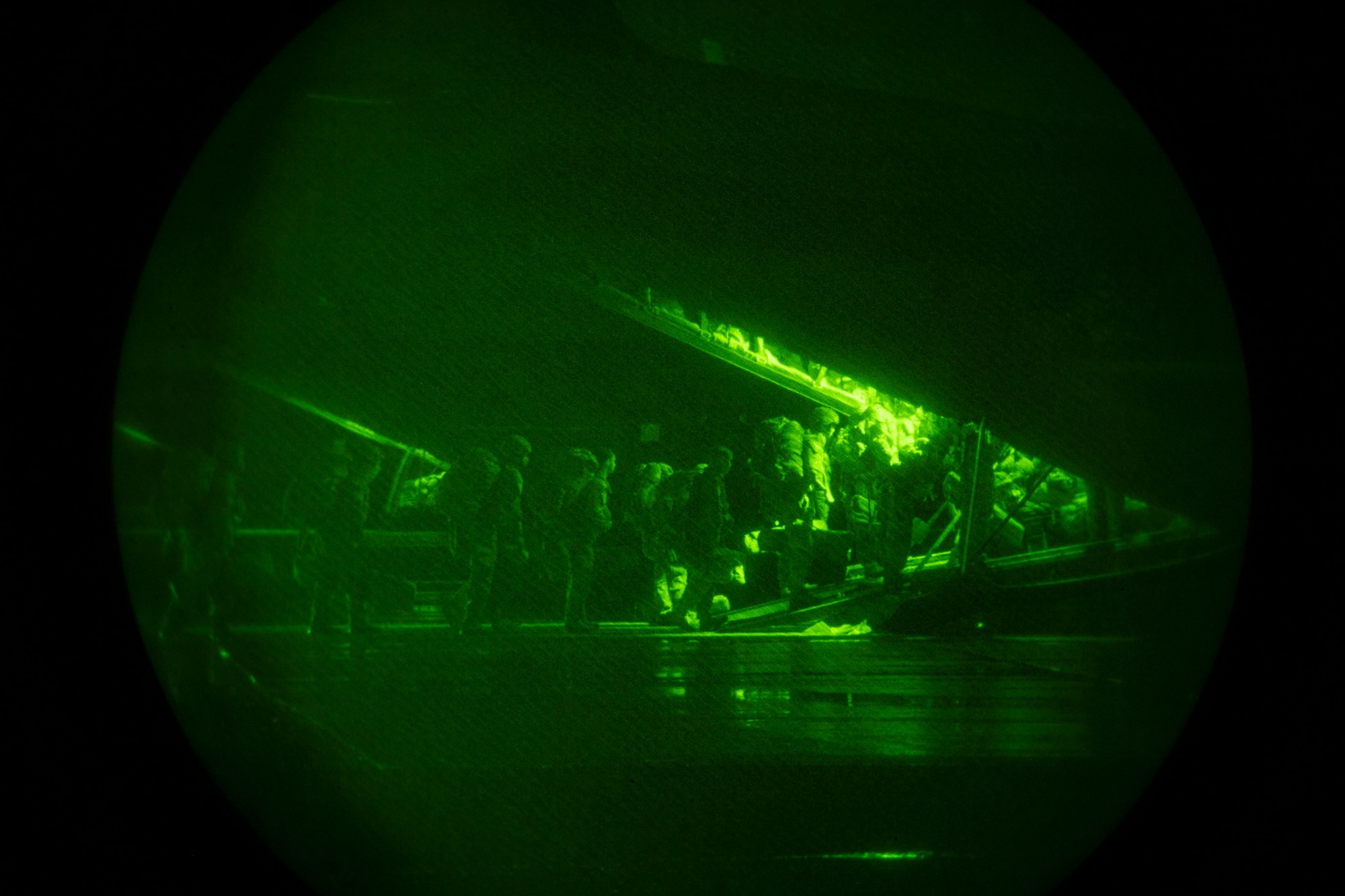 Paratroopers walk on to a C-130J Super Hercules.