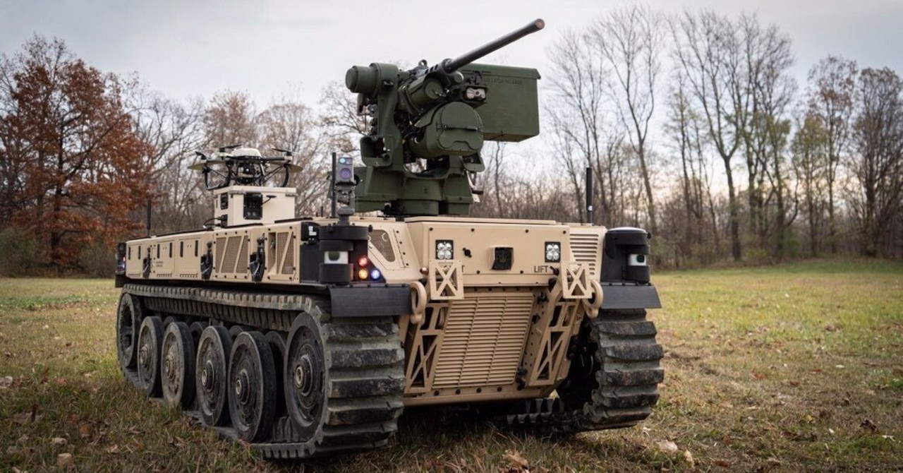 A tactical vehicle sits in grass.