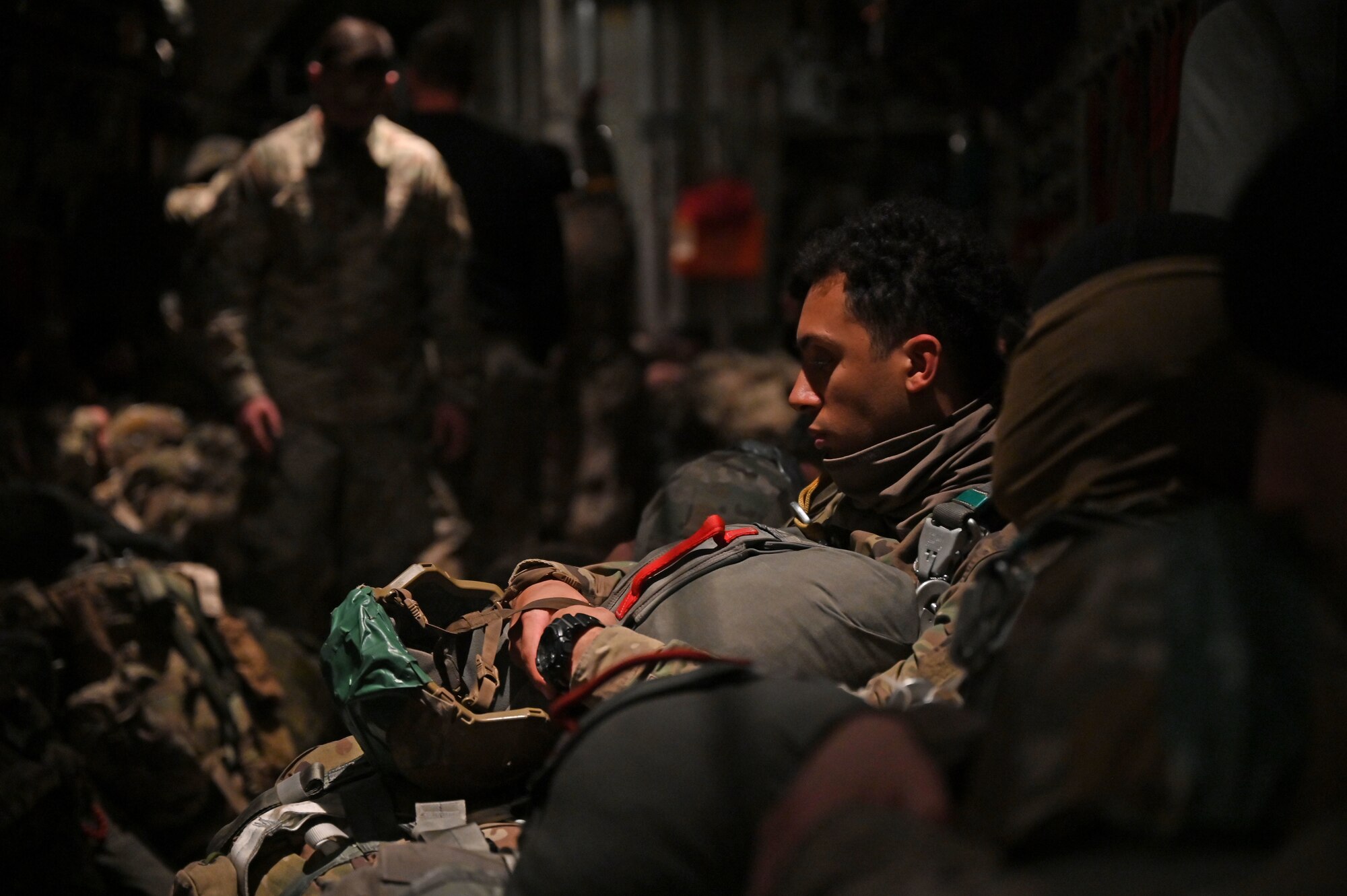 Paratroopers sit in the back of a C-130 prior to a static-line jump.