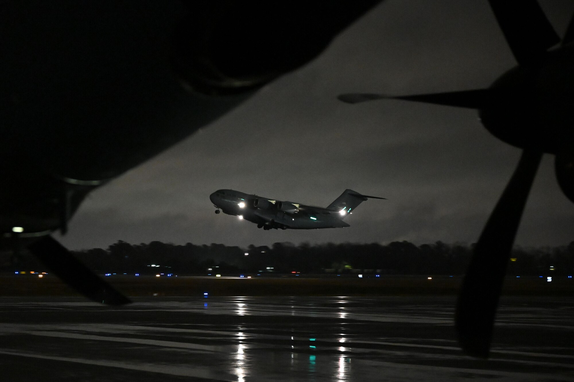 A C-17 takes off on the flightline at Charleston.