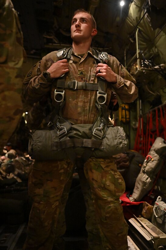 A paratrooper prepares for a static-line jump.