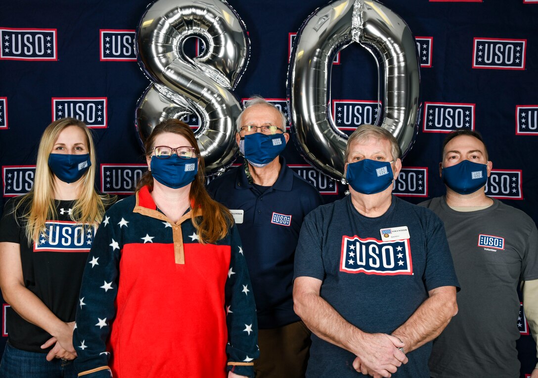 Cari Matthews, Center Operations Supervisor, and volunteers from United Services Organizations Delaware pose for a group photo during the USO 80th birthday celebration at Dover Air Force Base, Delaware, Feb. 4, 2021. USO Delaware celebrated its 80th birthday by providing service members a grab and go lunch, dessert and a tailgating essentials raffle. (U.S. Air Force photo by Airman 1st Class Stephani Barge)