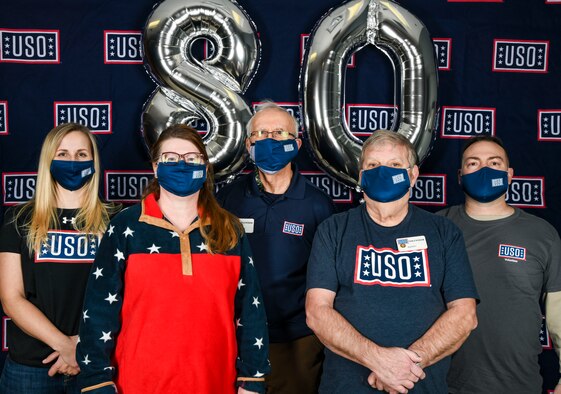 Cari Matthews, Center Operations Supervisor, and volunteers from United Services Organizations Delaware pose for a group photo during the USO 80th birthday celebration at Dover Air Force Base, Delaware, Feb. 4, 2021. USO Delaware celebrated its 80th birthday by providing service members a grab and go lunch, dessert and a tailgating essentials raffle. (U.S. Air Force photo by Airman 1st Class Stephani Barge)