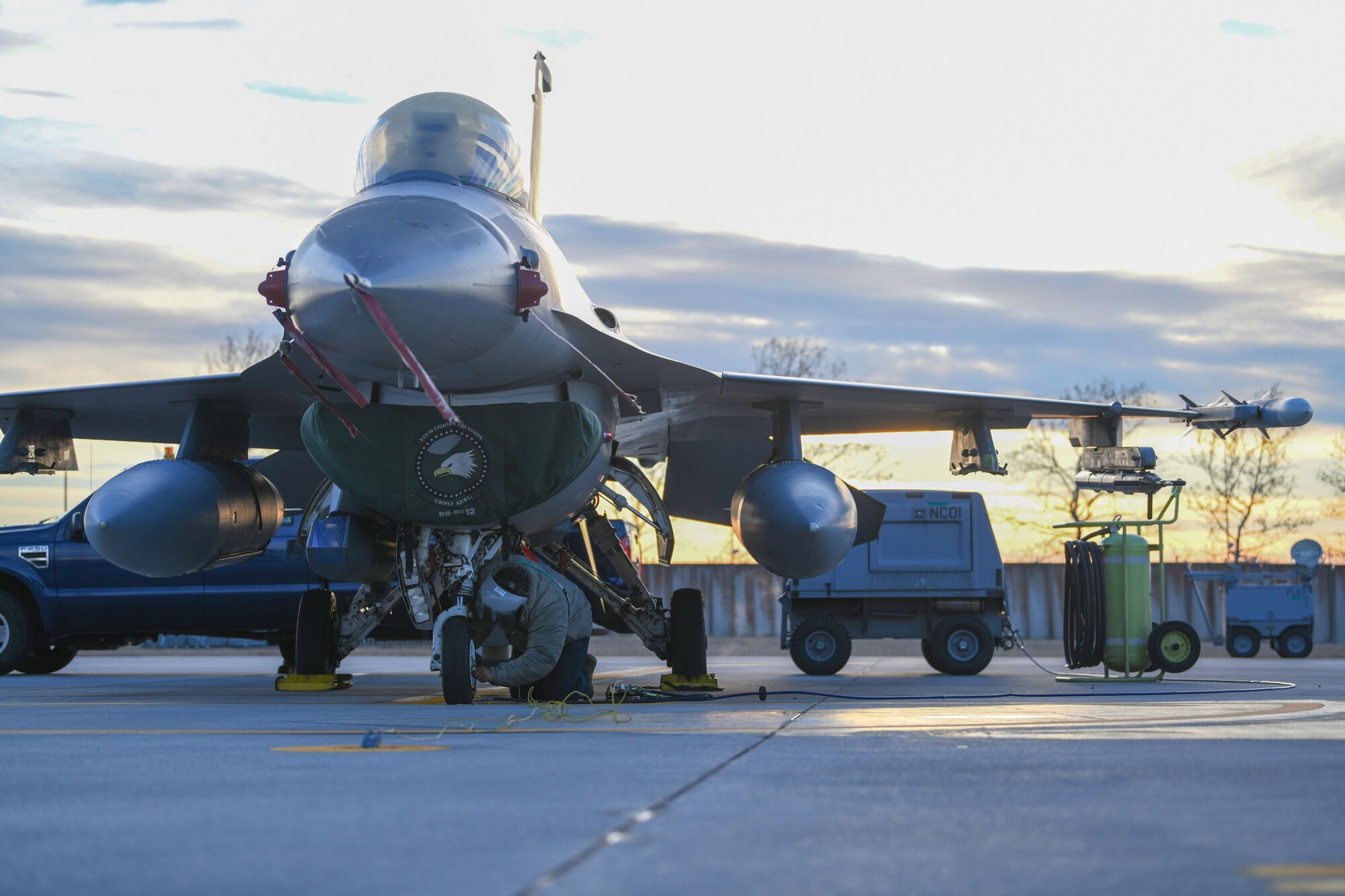 U.S. Air Force Airman 1st Class Alex Peguero, 31st Aircraft Maintenance Squadron assistant dedicated crew chief, services a tire of an F-16 Fighting Falcon at Aviano Air Base, Italy, Feb. 1, 2021. Crew chiefs routinely inspect and service the aircraft to ensure mission and operational readiness. (U.S. Air Force photo by Senior Airman Ericka A. Woolever).