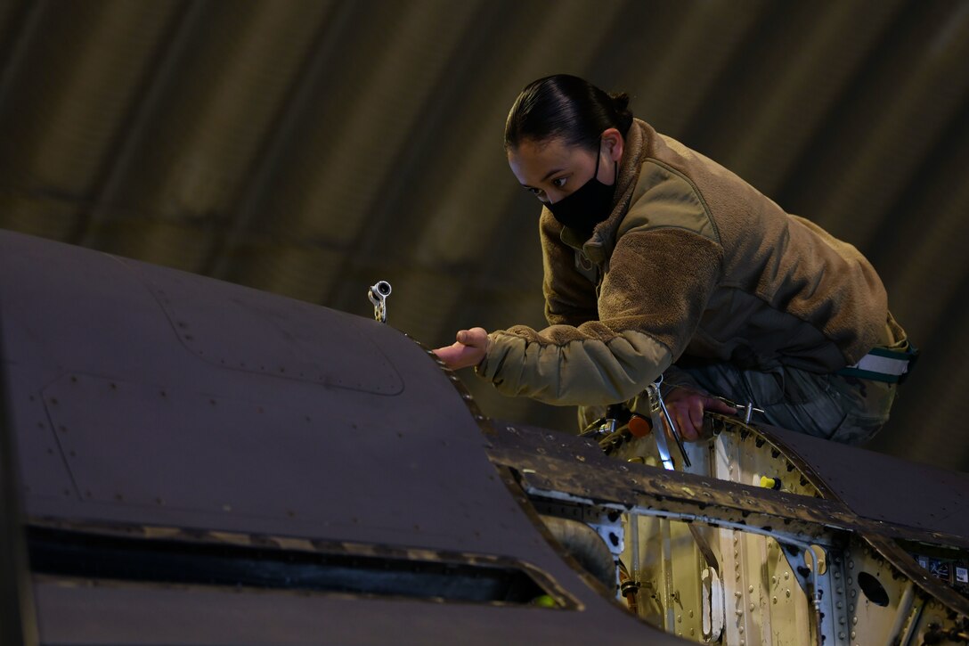 U.S. Air Force Tech. Sgt. Nicole Almario, 31st Aircraft Maintenance Squadron weapons load crew chief, examines the inside of an F-16 Fighting Falcon at Aviano Air Base, Italy, Feb. 1, 2021. Crew chiefs routinely inspect and service the aircraft to ensure mission and operational readiness. (U.S. Air Force photo by Senior Airman Ericka A. Woolever)