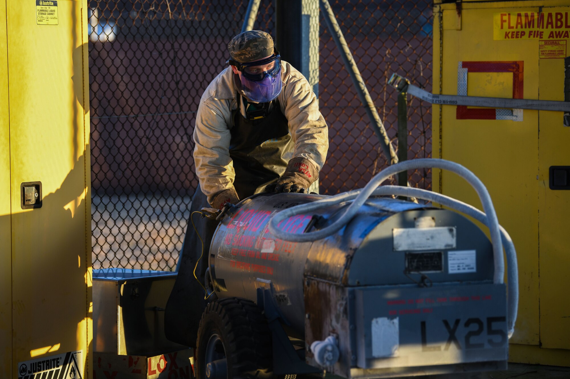 U.S. Air Force Airman 1st Class Jonah Schuline, 31st Aircraft Maintenance Squadron crew chief, services liquid oxygen bottles for multiple F-16 Fighting Falcons at Aviano Air Base, Italy, Feb. 1, 2021. Crew chiefs service the liquid oxygen bottles of the F-16s daily to ensure aircrews have breathable oxygen while flying. (U.S. Air Force photo by Senior Airman Ericka A. Woolever).